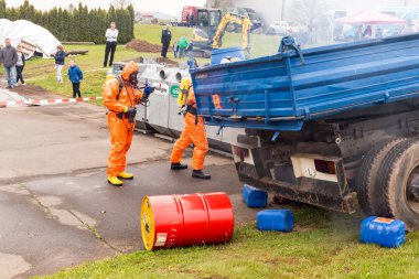 BLEIALF, GERMANY, MAY 7, 2017 - Fireman demonstrate how to handle hazardous material - public demonstration clipart