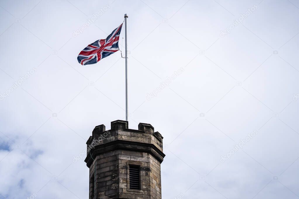 British Union Jack at Edinburgh Castle.Edinburgh castle Tower with Union Jack against blue sky