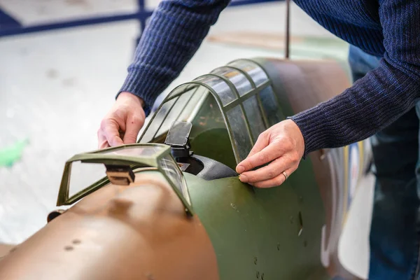 Man builds aircraft model.A high angle closeup shot of a detail of an aircraft model