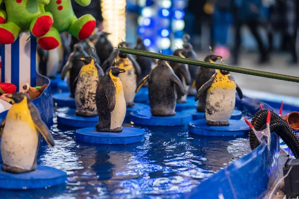 Gummipingviner med krokar i huvudet. Fairground krok en gummi pingviner chans spel — Stockfoto