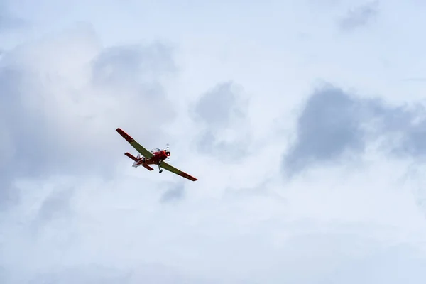 Малий літак з одним двигуном, що літає в англійському хмарному небі — стокове фото
