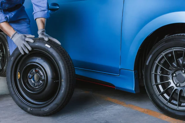 Asian man car inspection Measure quantity Inflated Rubber tires