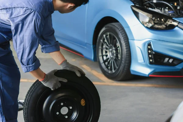 Hombre asiático inspección del coche Medida cantidad Neumáticos de goma inflados — Foto de Stock