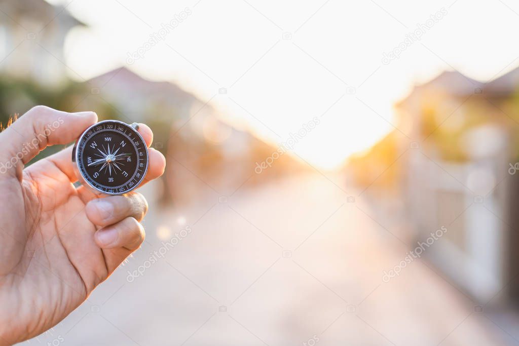 man holding compass on blurred background. for activity lifestyl