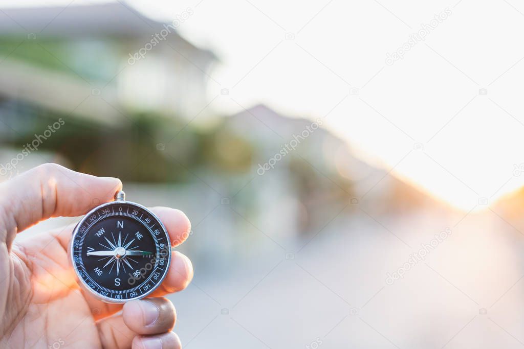 man holding compass on blurred background. for activity lifestyl