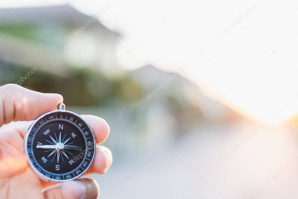 man holding compass on blurred background. for activity lifestyl