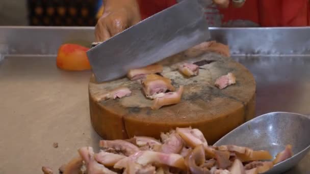 Крупным планом женщина на азиатском рынке режет сырое мясо — стоковое видео