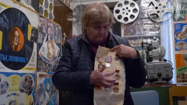 Старшая женщина показывает, какие медали были в России в старые времена — стоковое видео