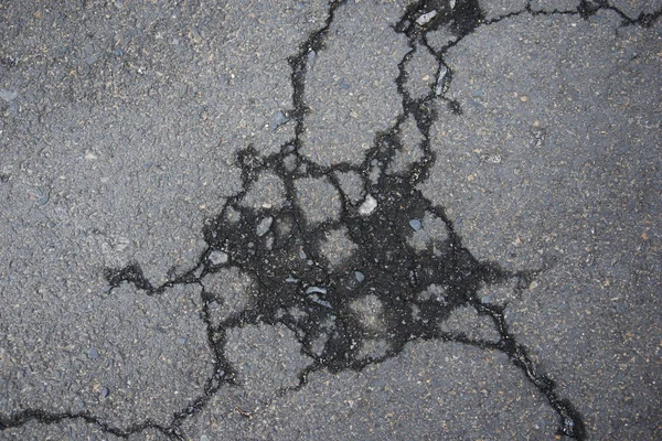 Cracked road alphalt texture, broken ground structure photo