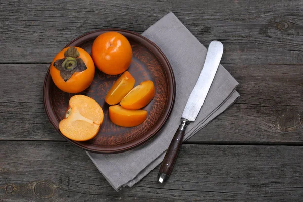 Japanese persimmons in ceramic plate — Stock Photo, Image