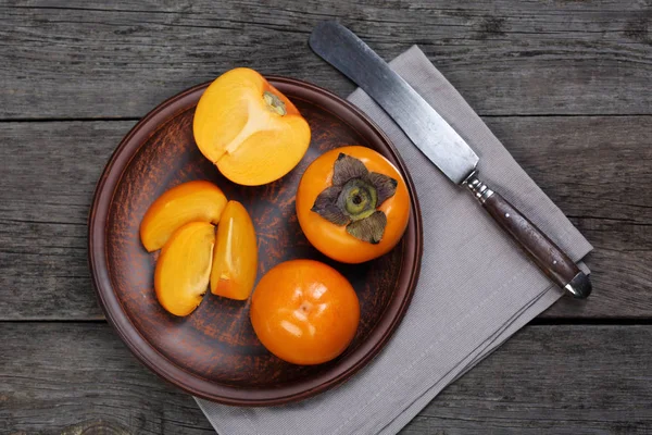 Japanese persimmons in ceramic plate — Stock Photo, Image