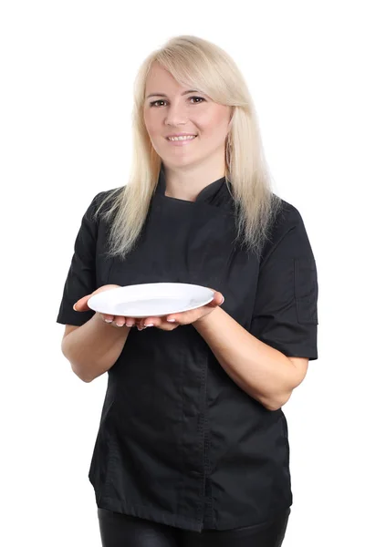 Woman chef in black uniform with empty plate isolated on white — Stock Photo, Image