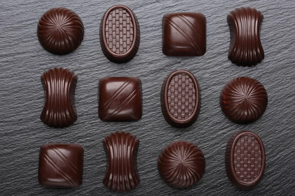 Chocolate candies on black slate stone background — Stock Photo, Image
