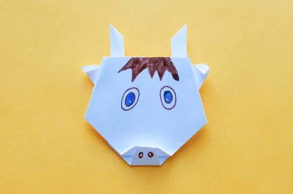 Adım 22. Sarı arka planda boğa, beyaz kağıttan yapılmış origami. Çocuk zanaatı konsepti.