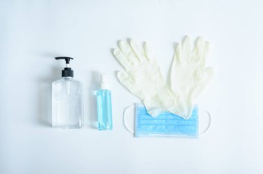 Mikrop korumalı Coronavirus veya Covid19 jel alkol veya beyaz arka planda el yıkama ve tıbbi eldiven için el dezenfektanı şişesi takmak için en iyi tıbbi maske.