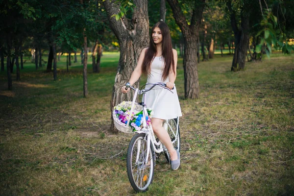 Young Smiling Woman Sits Bicycle Basket Flowers Evening Park — Stock Photo, Image