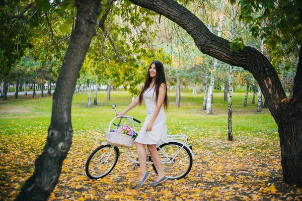 Girl White Skirt Vest Bicycle Basket Flowers Stands Yellow Leaves — Stock Photo, Image