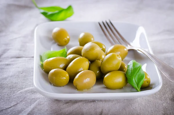 Green Olives Served Basil Leaves White Plate Stock Photo