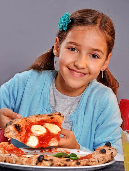 Girl holding pizza slice — Stock Photo, Image