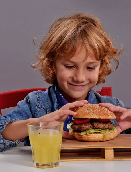 Criança comendo hambúrguer . — Fotografia de Stock