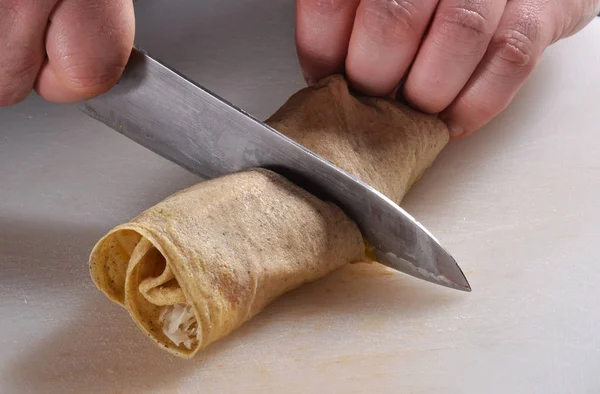 Cook cuts spring roll — Stock Photo, Image