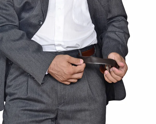 Businessman unbuckles his belt — Stock Photo, Image