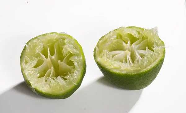 Two Halves Squeezed Lime White Closeup — Stock Photo, Image