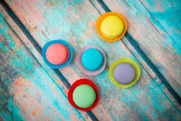 Multicolored macaroons on blue wooden table — Stock Photo, Image