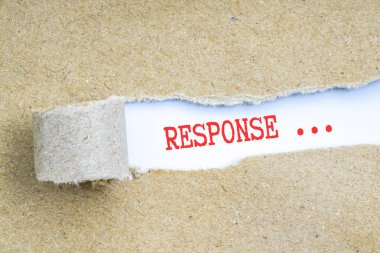 Kavramsal kırmızı metin ile kahverengi yırtık kağıt.