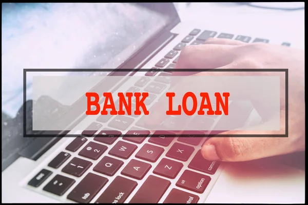 Hand and text BANK LOAN with vintage background. Technology concept.