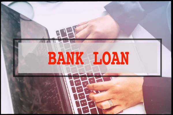 Hand and text BANK LOAN with vintage background. Technology concept.