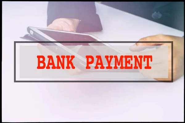 Hand and text BANK PAYMENT with vintage background. Technology concept.