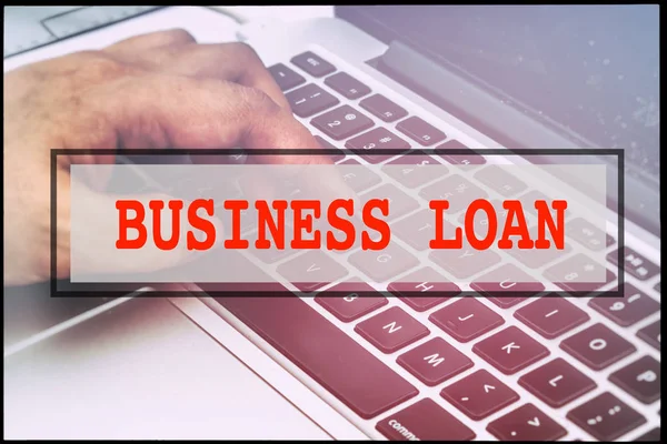 Hand and text  BUSINESS LOAN with vintage background. Technology concept.