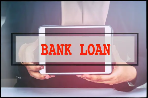 Hand and text BANK LOAN with vintage background. Technology concept.