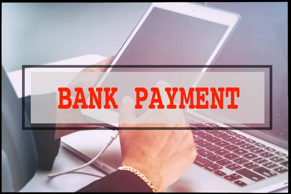 Hand and text BANK PAYMENT with vintage background. Technology concept.