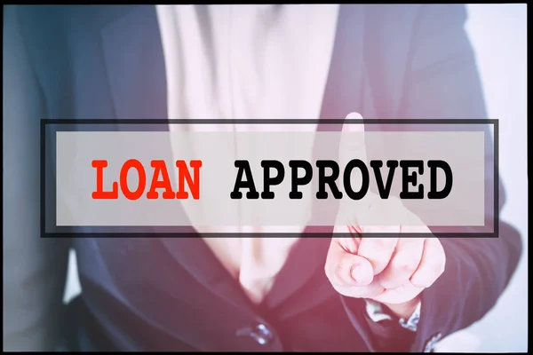 Hand and text LOAN APPROVED with vintage background. Technology concept.