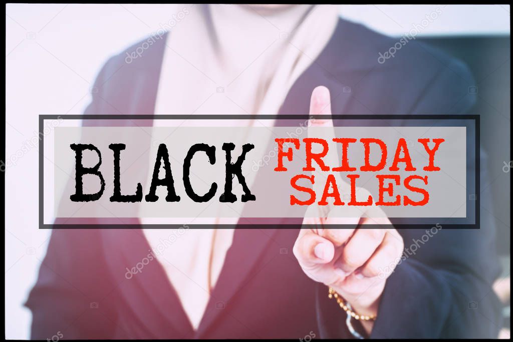 Hand and text BLACK FRIDAY SALES with vintage background. Technology concept.