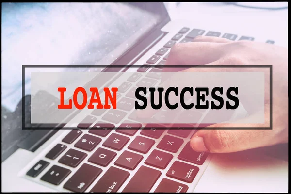 Hand and text LOAN SUCCESS with vintage background. Technology concept.