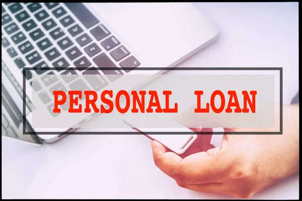 Hand and text  PERSONAL LOAN with vintage background. Technology concept.