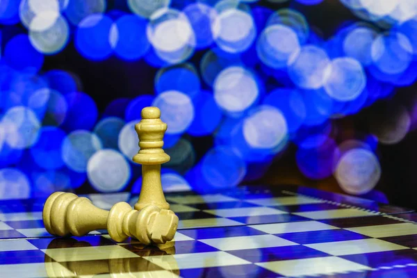 Chess pieces on board with bokeh background — Stock Photo, Image