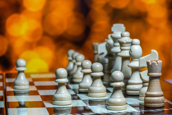 Chess pieces on board with bokeh background — Stock Photo, Image