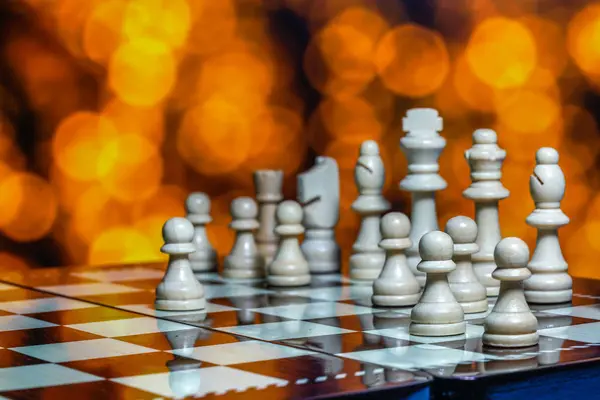 Chess pieces on board with bokeh background — Stock Photo, Image