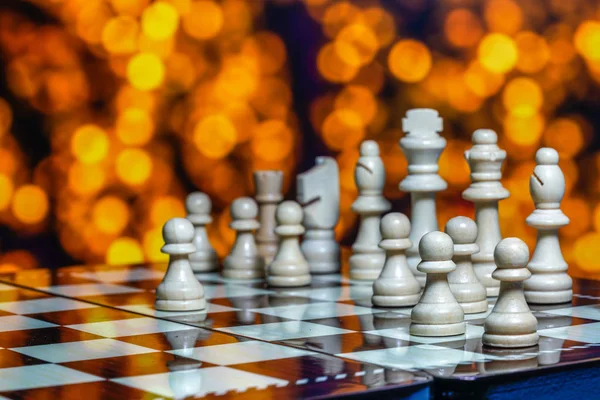 Chess pieces on board with bokeh background — Stock Photo, Image