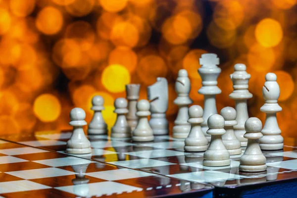 Chess pieces on board with bokeh background — Stock Photo, Image