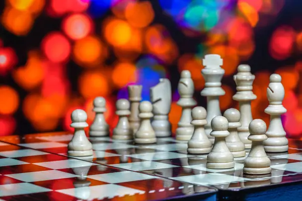 Chess pieces on board with bokeh background — Stock Photo, Image