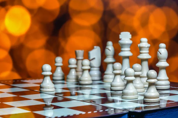 Chess pieces on board with bokeh background — Stock Photo, Image