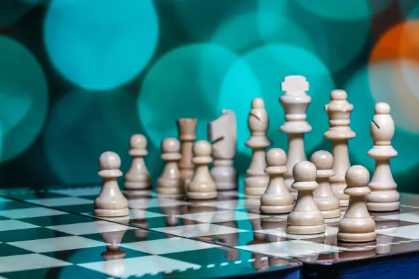 Chess pieces on board with bokeh background — Stock Photo, Image