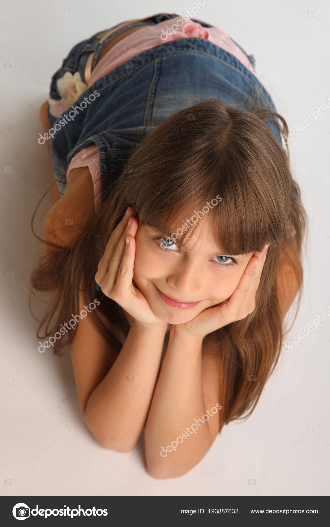 Portrait Beautiful Girl Denim Shorts Resting Floor Pretty Attractive Child  Stock Photo by ©AntonioClemens 193887632