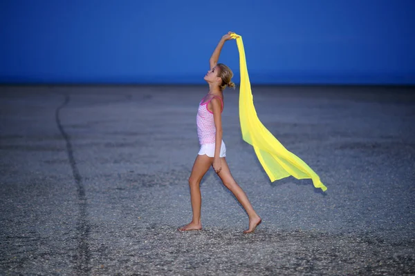 beautiful woman with yellow chiffon scarf posing outdoor