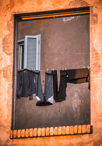 Roman broken facade with street lamps  and clothes hung out to dry